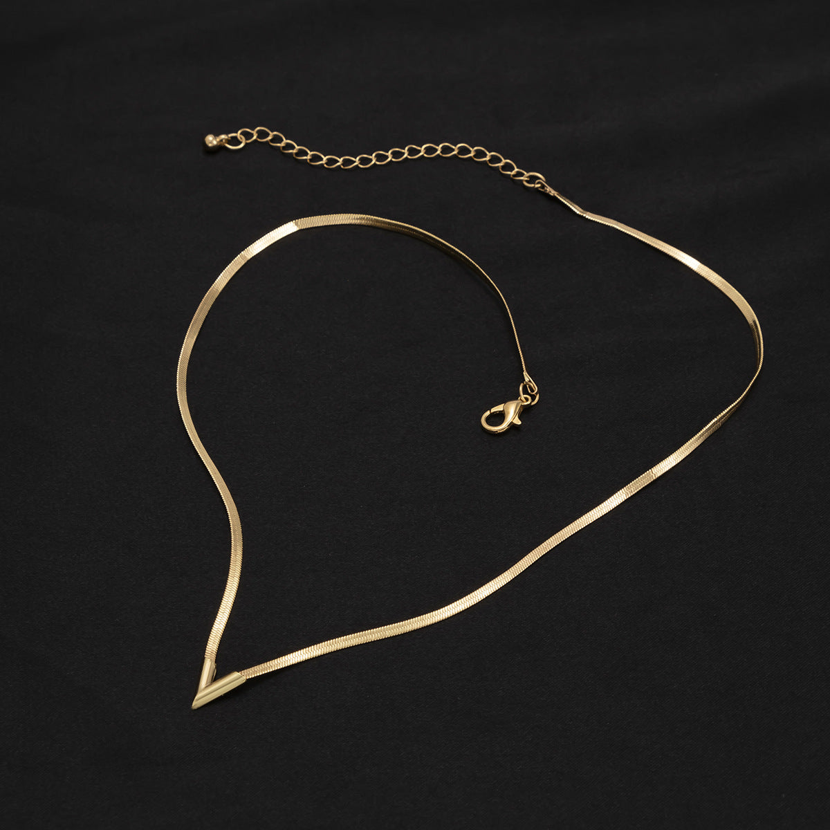 Gold necklace on a black background