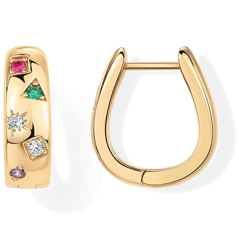 Gold hoop earrings with gemstones on a white background