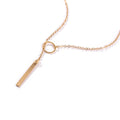 Gold necklace with a bar pendant on a white background
