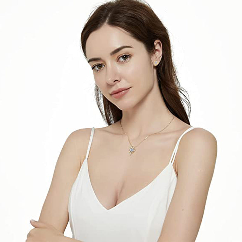 Woman wearing a white dress and gold necklace on a white background