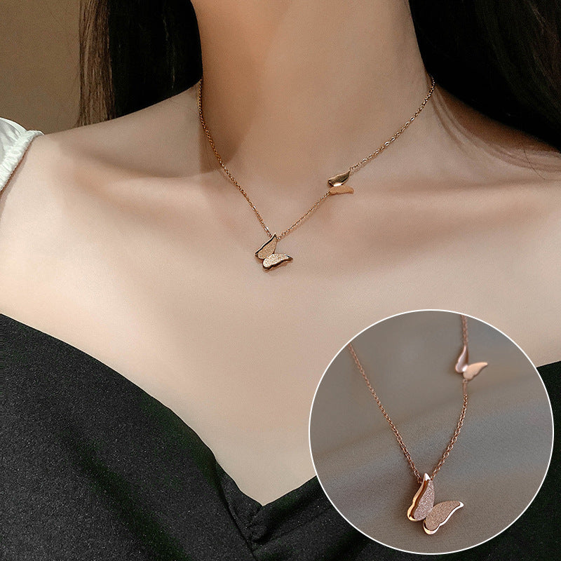 Rose gold necklace with heart-shaped pendants on a person's neck, with a close-up inset.