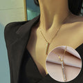 Gold necklace on a mannequin with close-up detail, set against a neutral background.