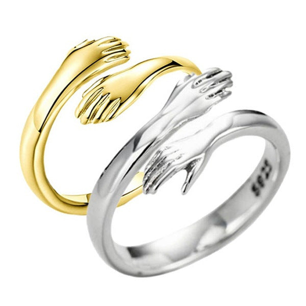 Gold and silver open hand-shaped rings on a white background