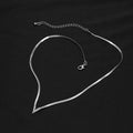 Silver necklace on a black background