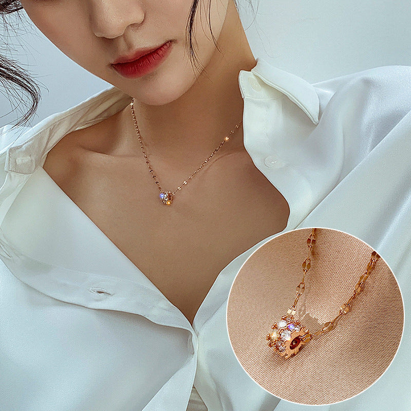 Woman wearing a gold necklace with a close-up inset on a light background