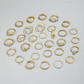 Collection of gold rings on a light gray background