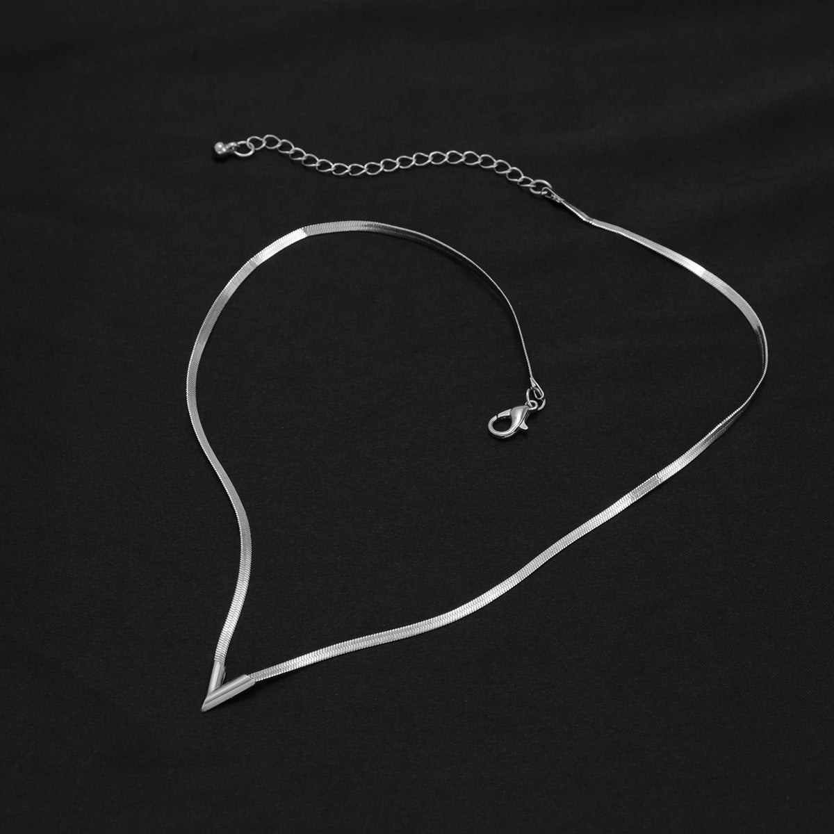 Silver necklace on a black background