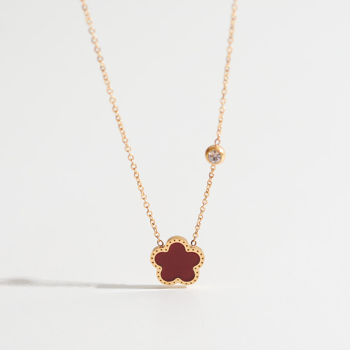 Necklace with a star-shaped pendant on a light gray background