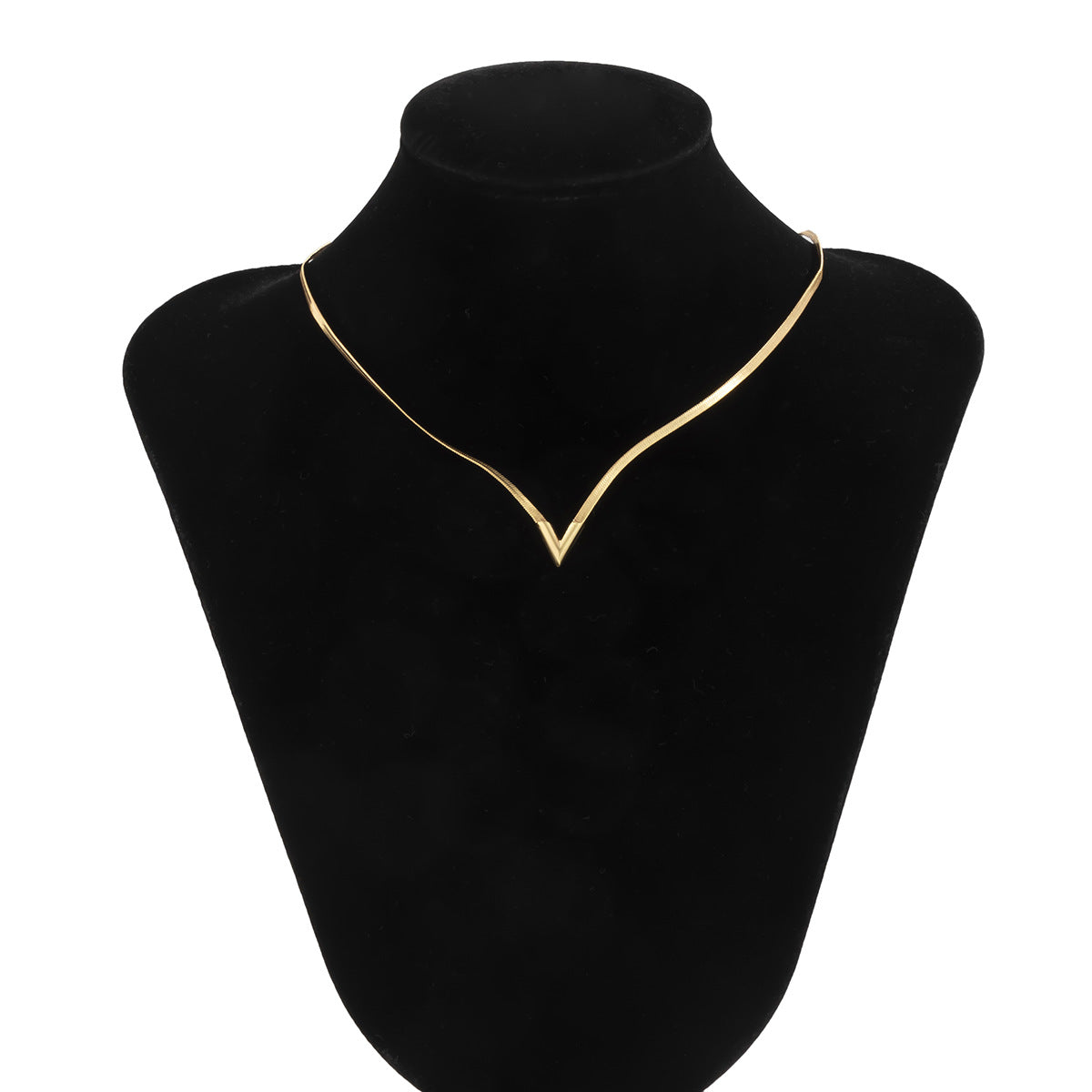 Gold necklace on a black velvet mannequin bust