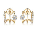 Gold earrings with diamond accents on a white background