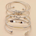 Set of silver bangles on a beige background