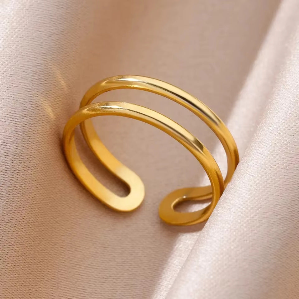Gold open ring on a soft beige fabric background