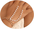 Pearl necklace and bracelet set on a person's wrist with a neutral background