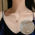 Rose gold necklace with a close-up inset on a person wearing a blue top.