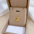 Gold heart-shaped necklace in a beige jewelry box