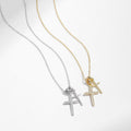 Two necklaces with cross pendants on a light gray background