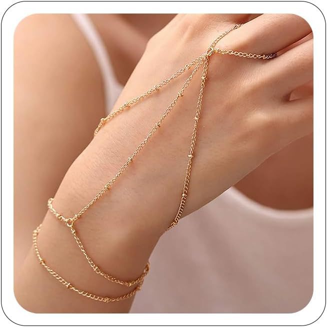 Gold chain anklets on a person's ankle against a neutral background