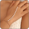 Pearl bracelet on a hand with a neutral background