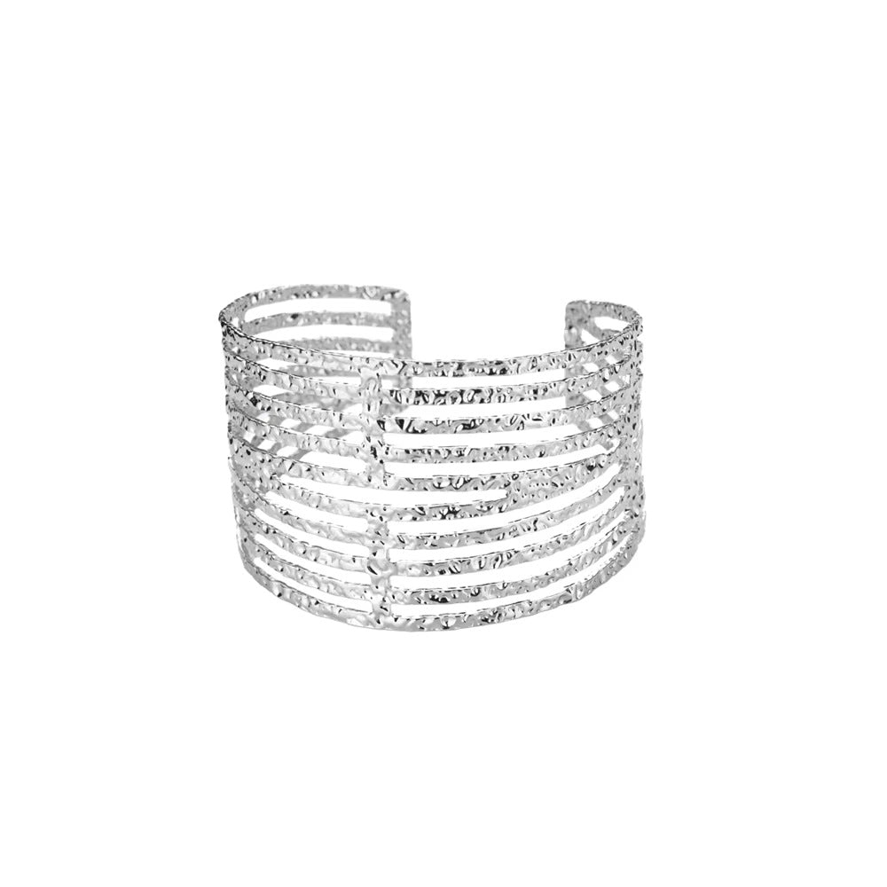 Silver cuff bracelet with multiple rows of crystals on a white background