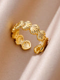 Gold ring with shell design on a beige fabric background