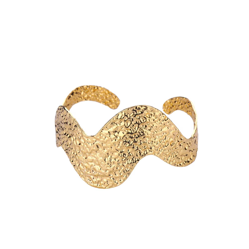 Gold textured ring on a white background