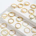 Collection of gold rings on a white surface