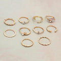 Collection of gold rings with various designs on a light background