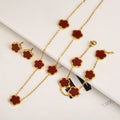 Gold necklace with red flower pendants on a white background