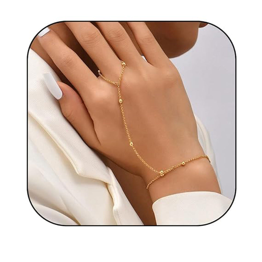 Gold bracelet on a hand with a white background