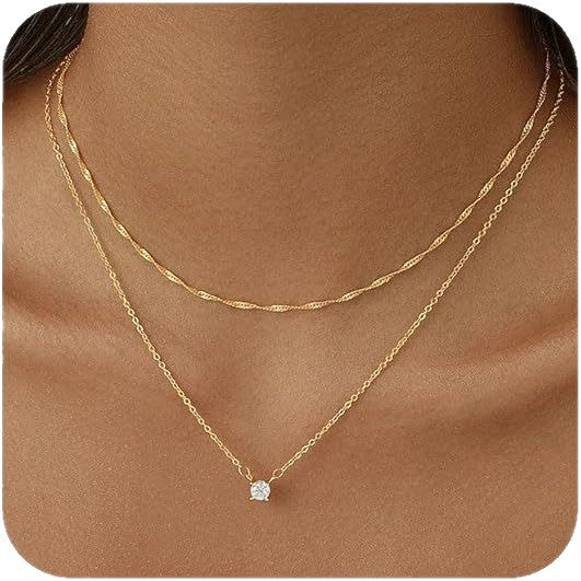 Gold necklace with a small diamond pendant on a brown background