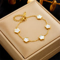 Gold bracelet with floral designs on a beige jewelry box