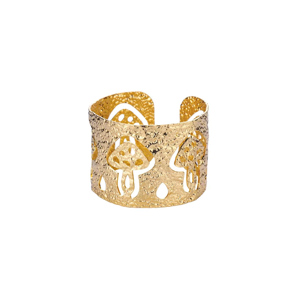 Gold bracelet with cut-out designs on a white background