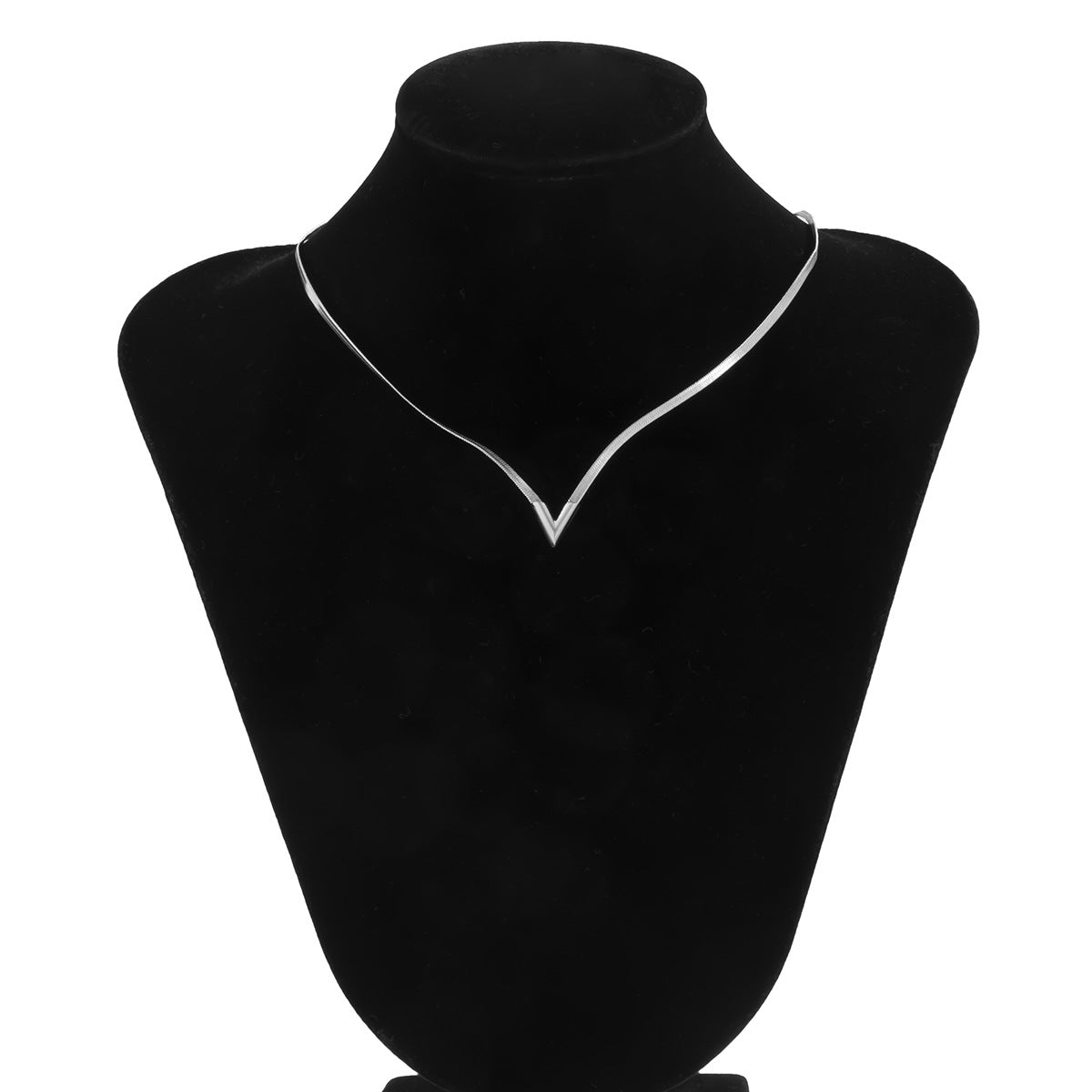 Necklace on a black velvet mannequin bust against a white background
